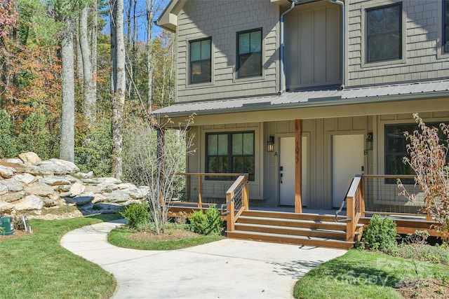 view of exterior entry with a porch