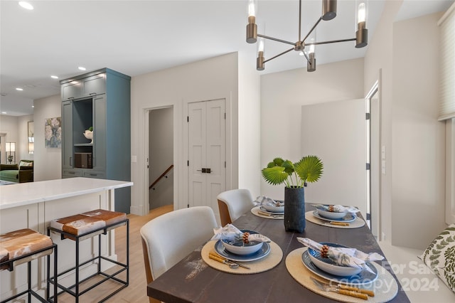 dining room featuring a notable chandelier and light hardwood / wood-style floors