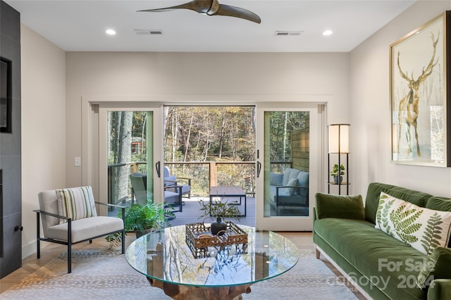 living room with hardwood / wood-style floors and ceiling fan