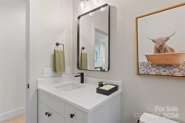 bathroom featuring toilet and vanity