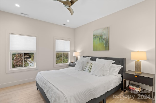 bedroom with light hardwood / wood-style floors and ceiling fan