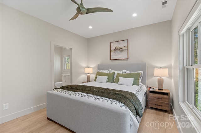 bedroom featuring light hardwood / wood-style floors, multiple windows, and ceiling fan