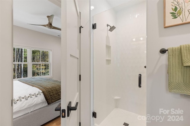 bathroom featuring a shower with door, ceiling fan, and hardwood / wood-style flooring