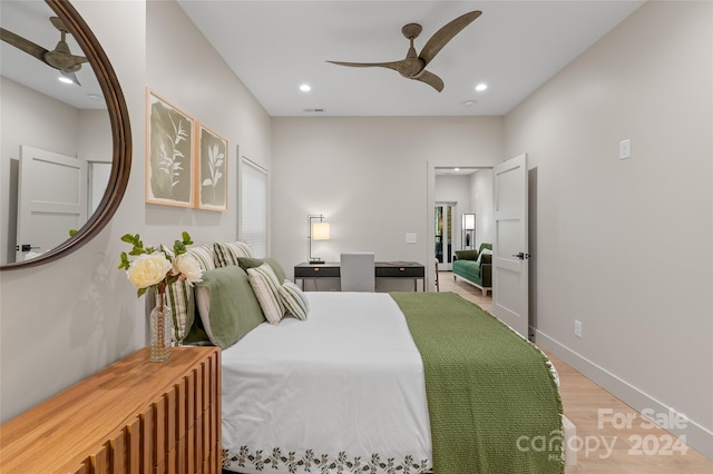 bedroom with ceiling fan, hardwood / wood-style flooring, and multiple windows