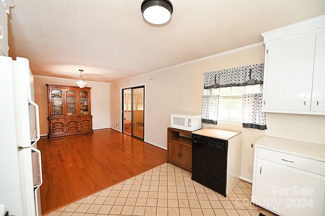 kitchen featuring white appliances, a textured ceiling, hanging light fixtures, white cabinetry, and light hardwood / wood-style flooring