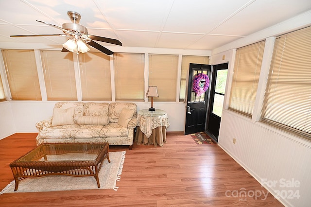 living area with hardwood / wood-style flooring and ceiling fan