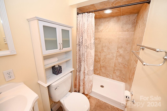 bathroom with toilet, a shower with shower curtain, and tile patterned flooring