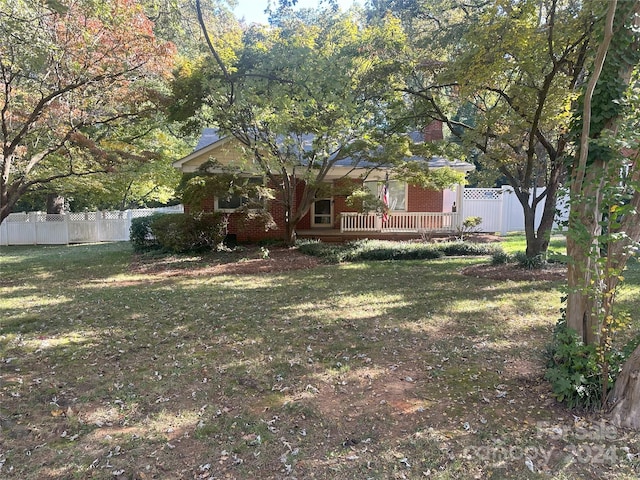 view of front of property with a front yard and a deck