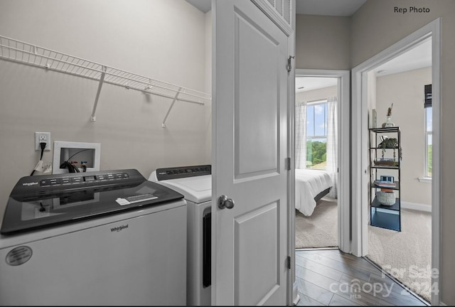 washroom featuring wood-type flooring and separate washer and dryer