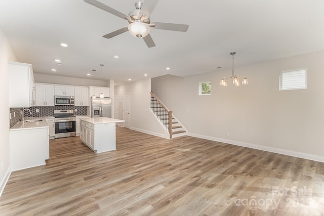 9247 Eleanor Dr, Charlotte, NC 28214 - kitchen featuring stainless steel appliances, a sink, a chandelier, plenty of natural light, and recessed lighting