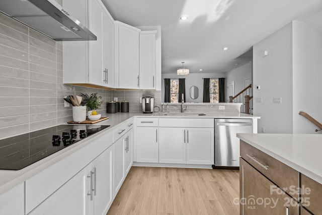 kitchen with sink, white cabinetry, range hood, dishwasher, and black electric stovetop