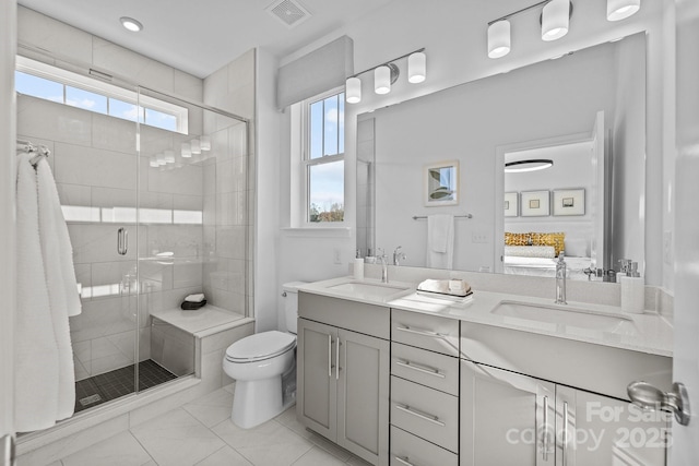 bathroom with toilet, vanity, walk in shower, and plenty of natural light