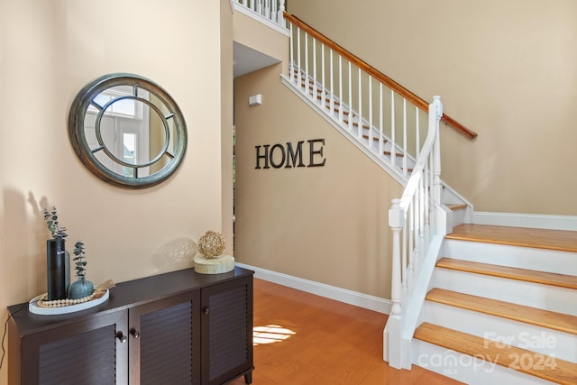 staircase with hardwood / wood-style floors