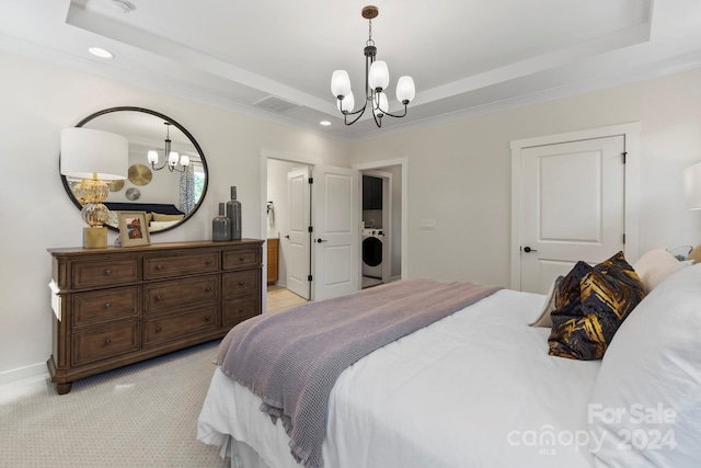 bedroom featuring washer / dryer, a notable chandelier, a raised ceiling, and light colored carpet