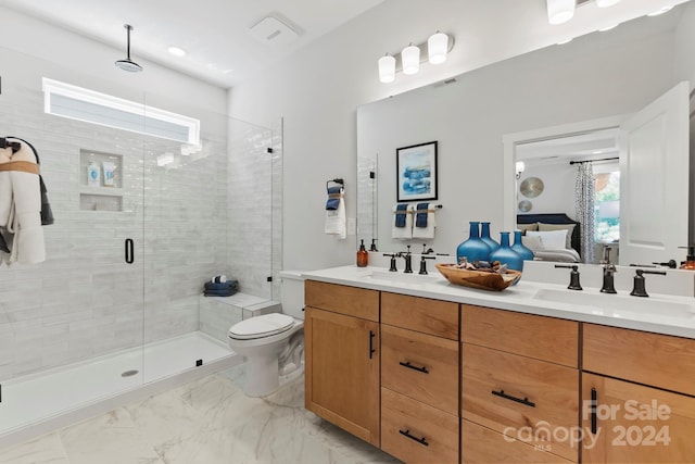 bathroom featuring vanity, an enclosed shower, and toilet