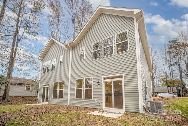 back of property featuring central AC