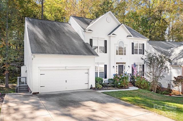 view of front of property with a front lawn and a garage