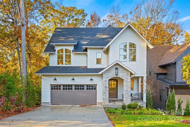 view of front of property with covered porch and a garage