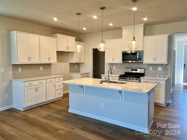 kitchen with dark hardwood / wood-style floors, white cabinetry, sink, and appliances with stainless steel finishes