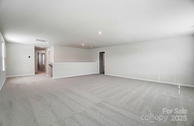 unfurnished room featuring baseboards, recessed lighting, visible vents, and light colored carpet