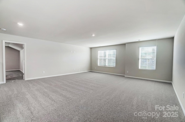 carpeted spare room with baseboards