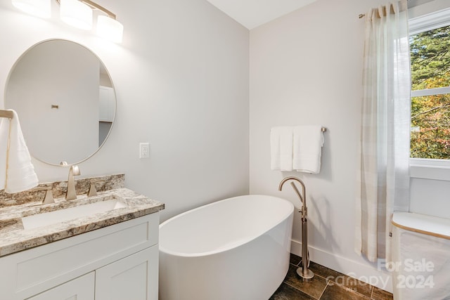 bathroom featuring vanity and a tub to relax in