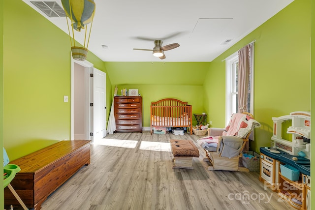 bedroom with vaulted ceiling and light wood-type flooring