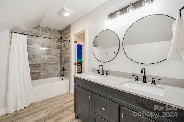 bathroom featuring vanity, lofted ceiling, shower / bath combo, and hardwood / wood-style flooring