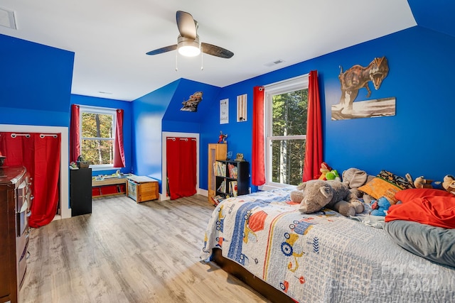 bedroom featuring vaulted ceiling, light hardwood / wood-style flooring, and ceiling fan