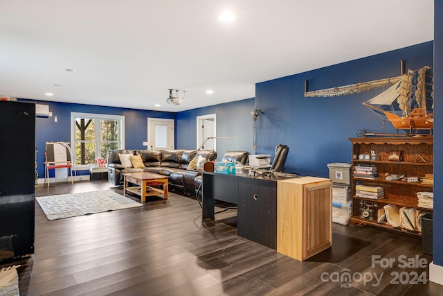 office space featuring a wall unit AC and dark hardwood / wood-style floors