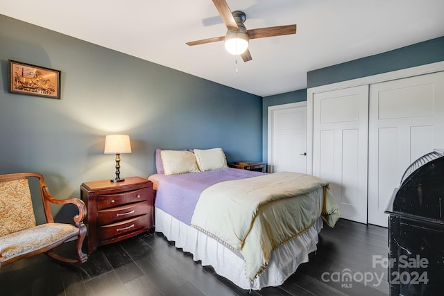 bedroom featuring dark wood-type flooring, a closet, and ceiling fan