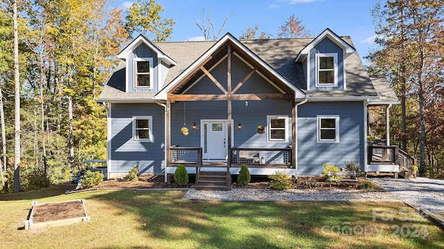 cape cod-style house with covered porch and a front lawn