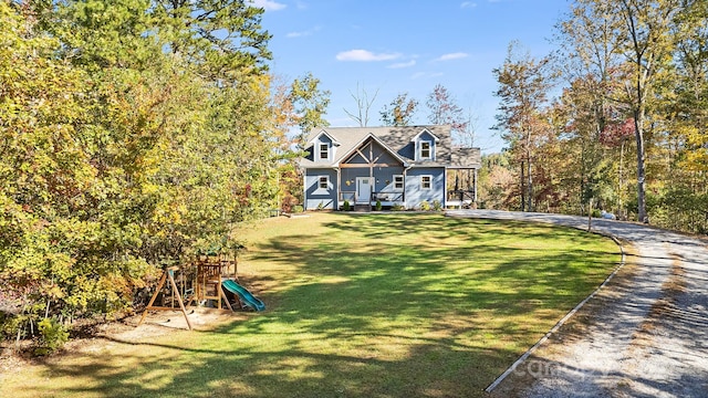 view of front of property with a playground and a front yard