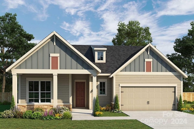 view of front of home with a front yard and a garage