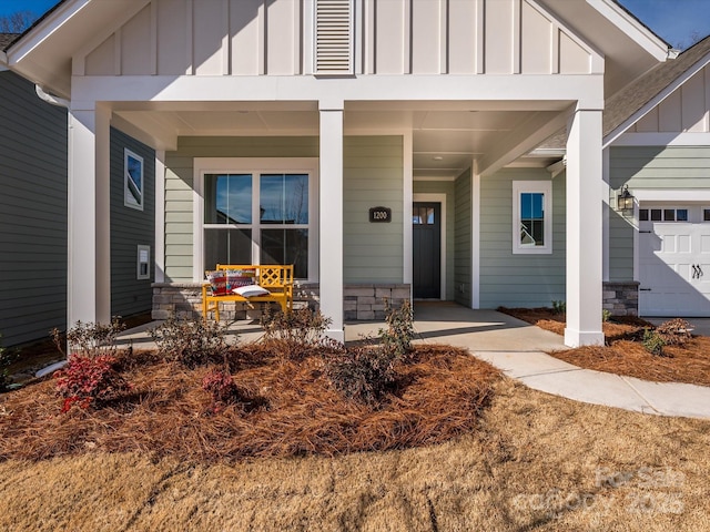 entrance to property with a porch and a garage