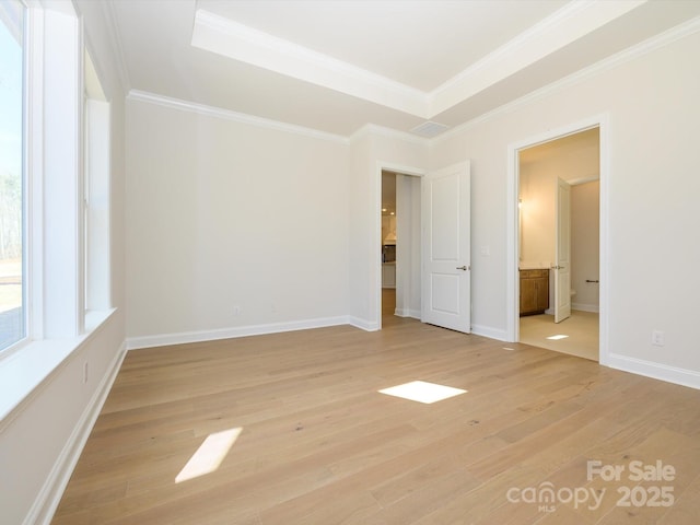 unfurnished bedroom with crown molding, ensuite bathroom, and light wood-type flooring