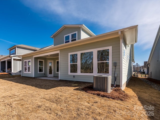 rear view of house featuring cooling unit and a patio