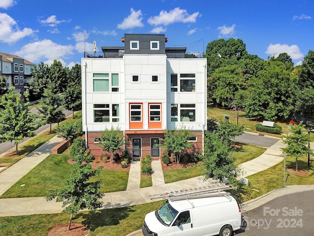 contemporary home featuring a front lawn