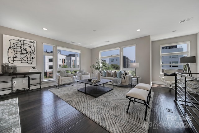 living room with a healthy amount of sunlight and dark hardwood / wood-style flooring