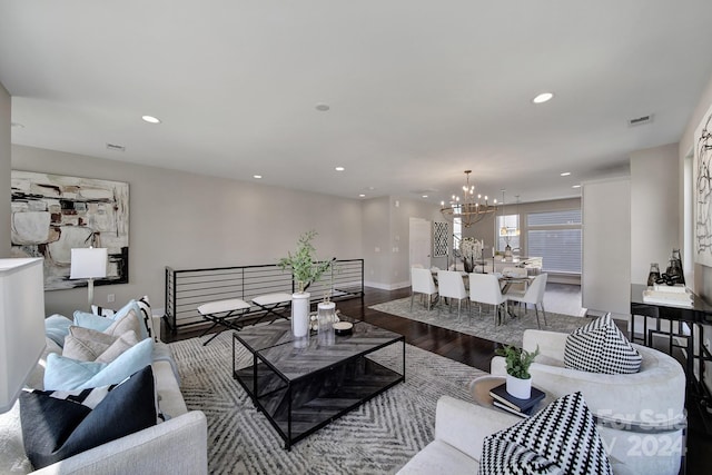 living room featuring a chandelier and wood-type flooring