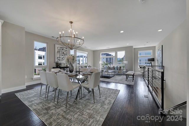 dining area featuring an inviting chandelier, a healthy amount of sunlight, and dark wood-type flooring