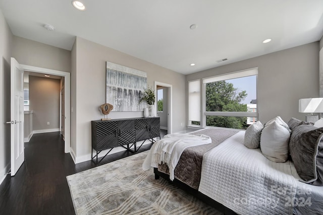 bedroom with dark hardwood / wood-style flooring