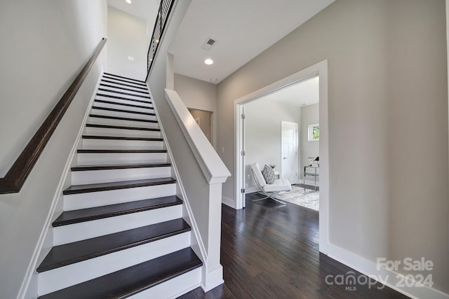 staircase featuring wood-type flooring