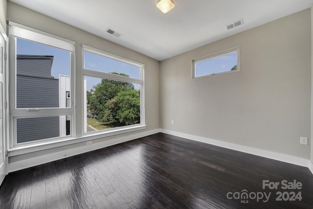 unfurnished room with hardwood / wood-style flooring