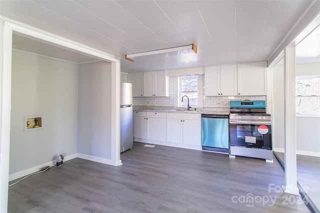 kitchen featuring hardwood / wood-style floors, white cabinetry, and stainless steel appliances