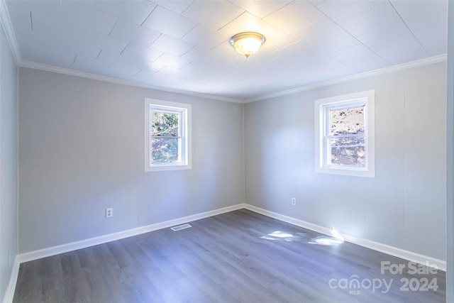 spare room with crown molding and dark hardwood / wood-style flooring