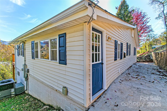 view of home's exterior with a patio area and central AC unit