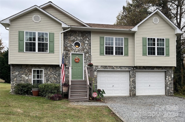 raised ranch featuring a front yard and a garage