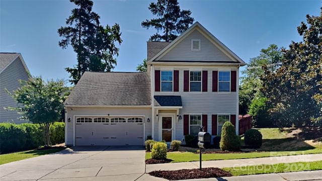 view of front of house featuring a front lawn and a garage