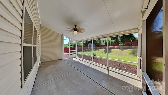 unfurnished sunroom featuring ceiling fan and vaulted ceiling